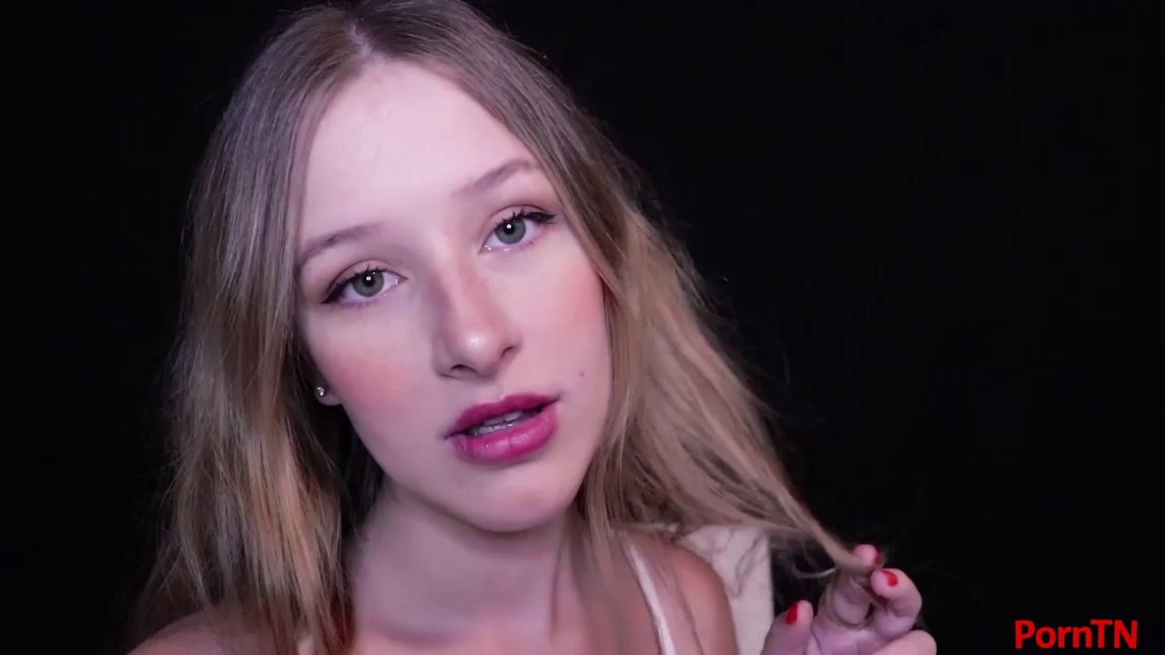 Flirty blonde babe with braces is playing with her tits in front of the camera